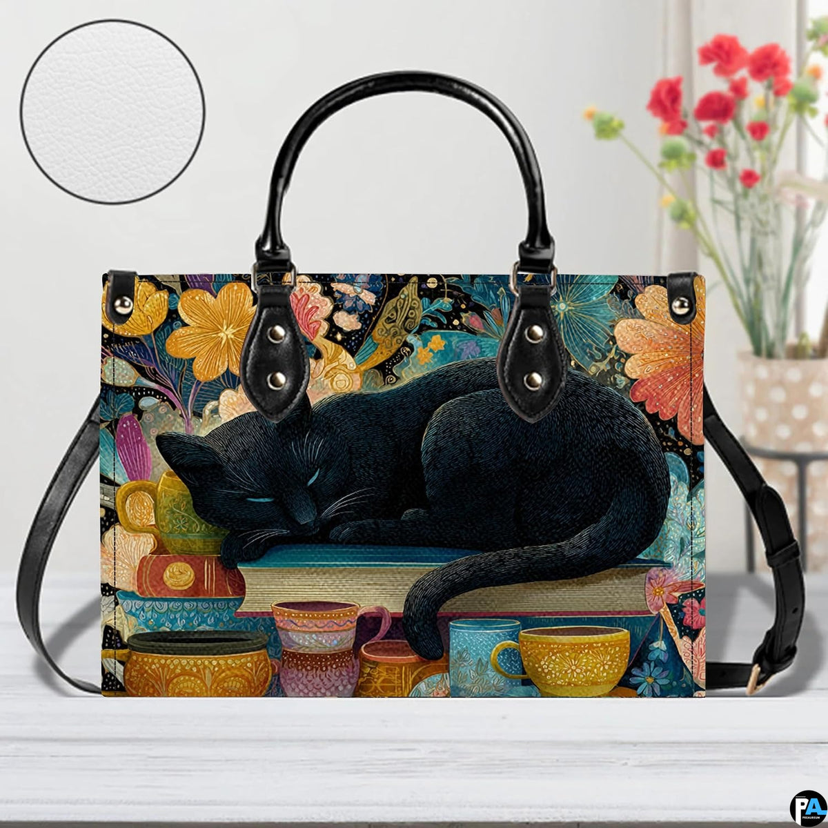 Close studio perspective of sleeping black cat art positioned on white surface beside flowers.