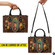 Angled perspective showing Our Lady of Guadalupe religious artwork on structured handbag