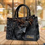 Close-up front view of handbag showing sculpted Jesus portrait with crown of thorns