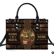 Front view of structured handbag showing green dragon with spectacles reading books against antique library backdrop