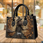 Gothic autumn witch handbag displayed on wooden tabletop in front of sunlit windows.