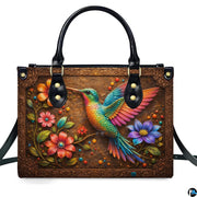 Handbag standing upright on wooden tabletop in softly lit indoor room.