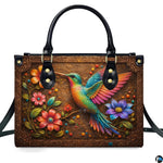 Handbag standing upright on wooden tabletop in softly lit indoor room.