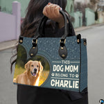 Angled display of dog lover handbag paired with coordinating zippered wallet companion.