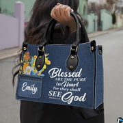 Street lifestyle view of scripture denim wildflower handbag held by hand on sidewalk
