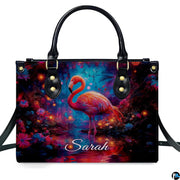 Lifestyle view of the glowing flamingo handbag on a city sidewalk.