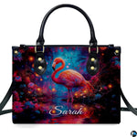 Lifestyle view of the glowing flamingo handbag on a city sidewalk.