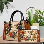 Handbag and matching wallet set arranged together on tabletop setting beside houseplant.