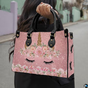 Top down view of floral unicorn handbag showing zipper closure and interior opening.