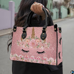 Top down view of floral unicorn handbag showing zipper closure and interior opening.