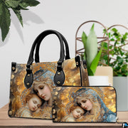 Bejeweled Mary and baby Jesus handbag and matching wallet displayed on table next to green plants