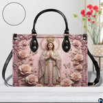 Top view of Virgin Mary handbag displaying opening and top carry handles