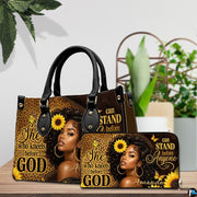 Melanin leopard faith print art resting on a wooden surface beside lush green foliage.