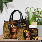Melanin leopard faith print art resting on a wooden surface beside lush green foliage.