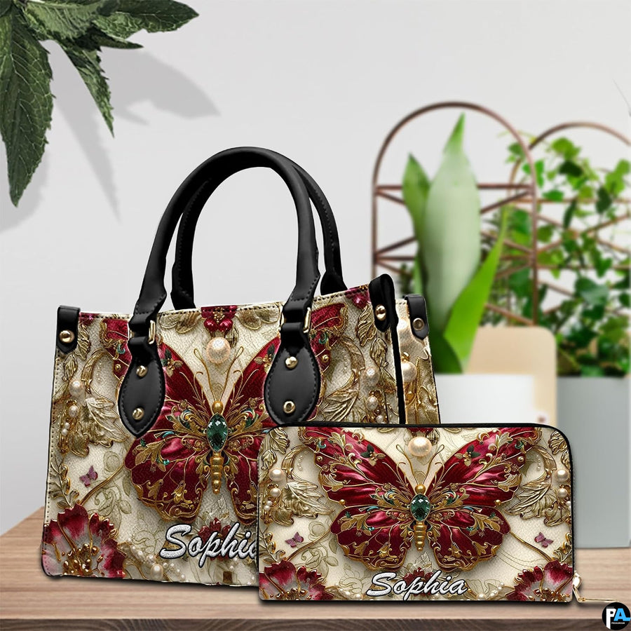 Close-up front view of handbag showing ruby butterfly with gold filigree