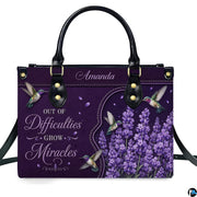 Purple hummingbird handbag displayed with matching continental wallet