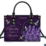 Purple hummingbird handbag displayed with matching continental wallet
