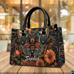 Three-quarter angle view of vintage moth handbag and wallet set