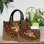 Front view of crowned giraffe handbag displaying regal gold tiara and warm earth tones.