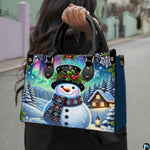 Front view of Northern Lights purse displaying smiling snowman, illuminated cabin, and starry skies.
