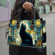 Outdoor street view showcasing the colorful cat stained glass art held during a sunny outing.