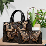 Sculpted butterfly handbag and matching wallet displayed together on a wooden tabletop near houseplants.