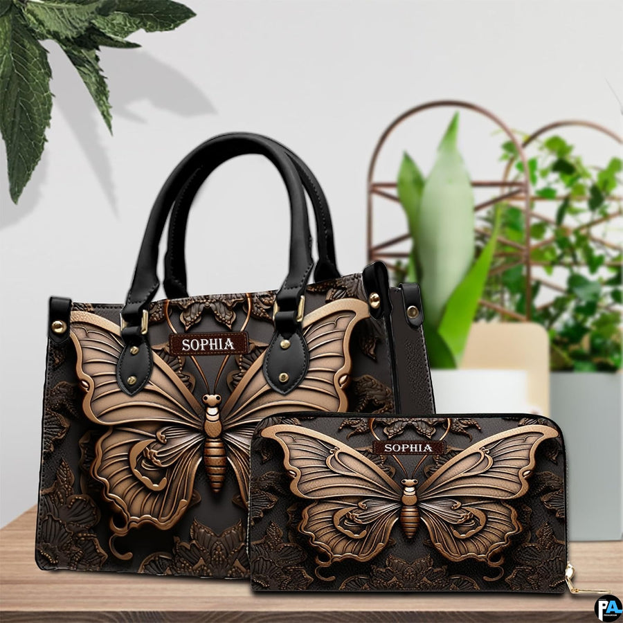 Sculpted butterfly handbag and matching wallet displayed together on a wooden tabletop near houseplants.