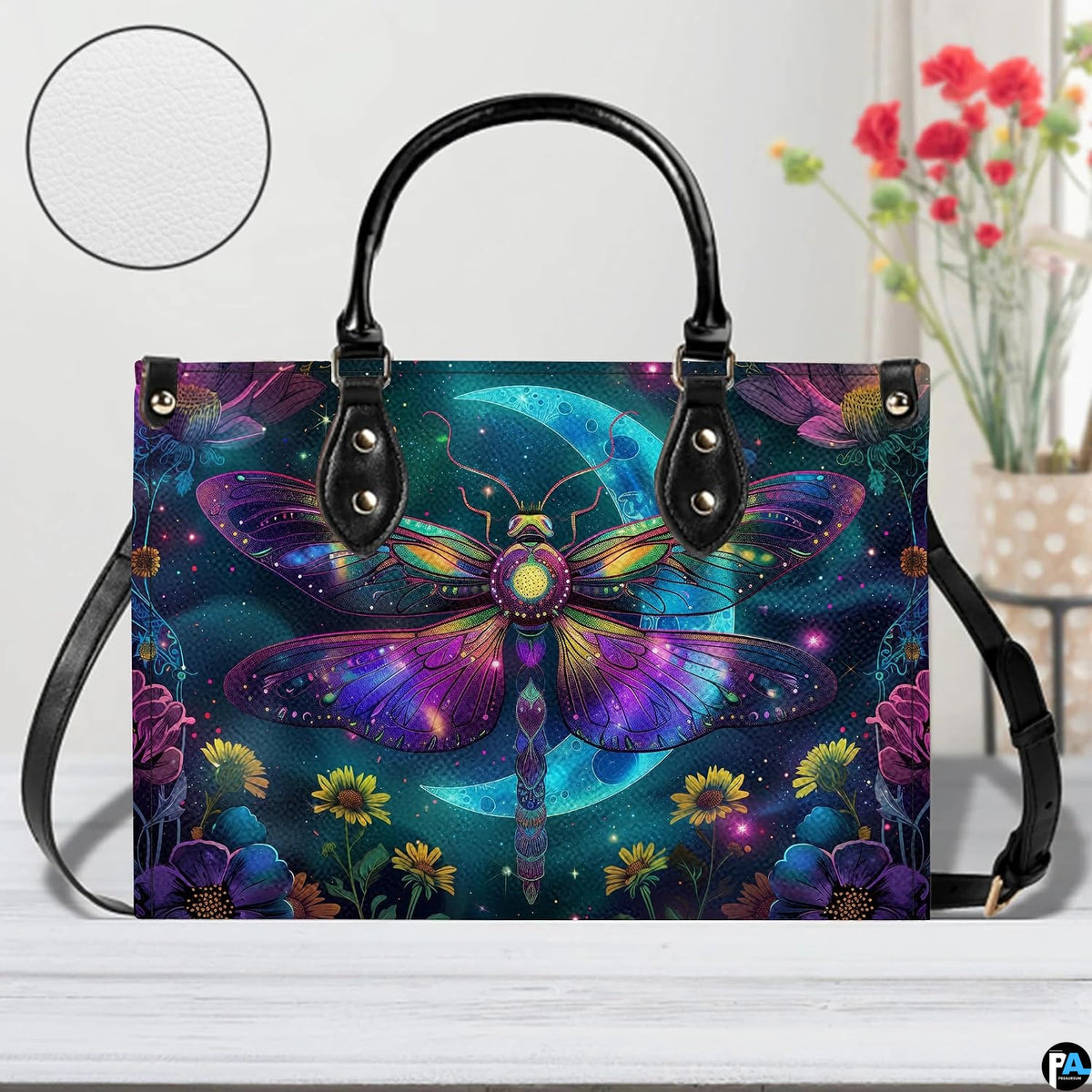 Bottom view of celestial moth handbag showing protective metal feet studs and smooth base wrap