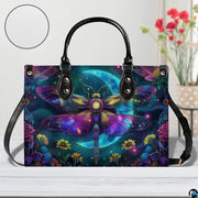 Bottom view of celestial moth handbag showing protective metal feet studs and smooth base wrap