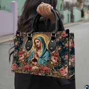 Model carrying the devotional Madonna in prayer handbag outdoors along a street