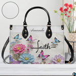 Side perspective view of floral butterfly handbag and wallet showing structured profile