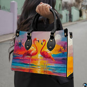 Outdoor lifestyle view of model carrying the tropical sunset flamingo handbag.