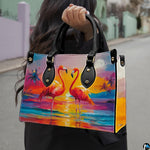 Outdoor lifestyle view of model carrying the tropical sunset flamingo handbag.