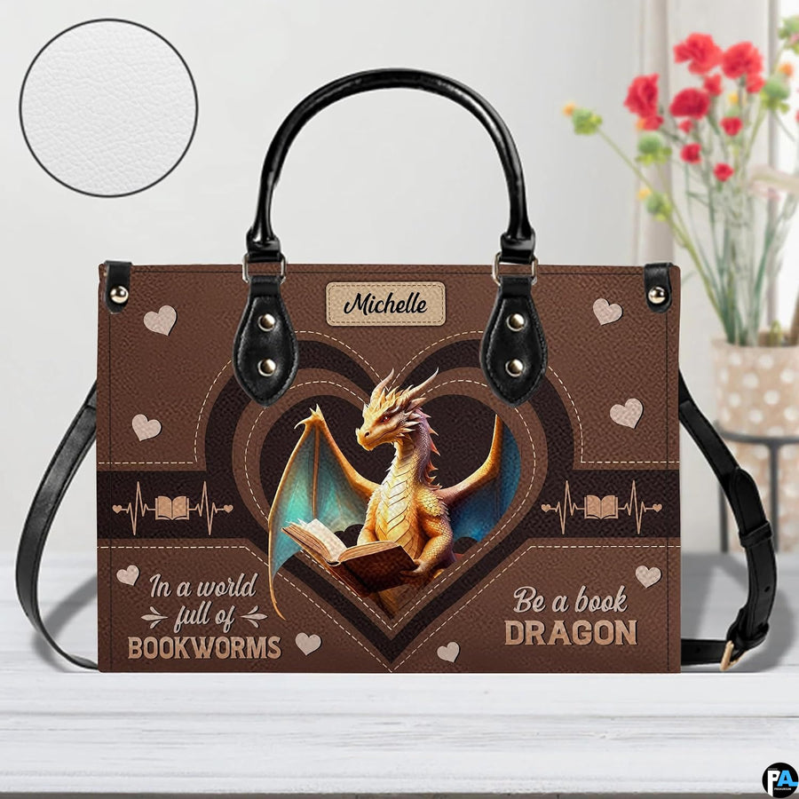 Close-up detail of handbag highlighting textured surface, heart accents, and golden dragon artwork
