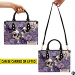 Lavender skull handbag on white table beside floral bouquet with texture swatch inset.