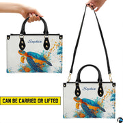 Matching wallet displaying the vibrant splatter droplet sea turtle and coral reef.