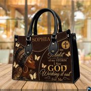Lifestyle view of brown leopard headwrap portrait handbag with gold butterfly and cross motifs
