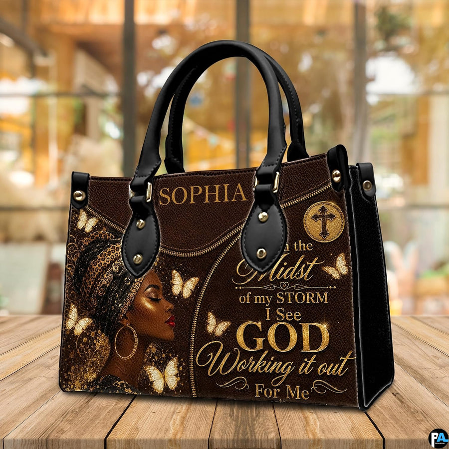 Lifestyle view of brown leopard headwrap portrait handbag with gold butterfly and cross motifs