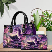 Reading dragon handbag and wallet set displayed on wooden table beside houseplant.