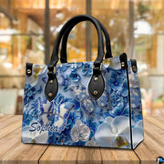 Alternative angle display of blue and white butterfly handbag and wallet