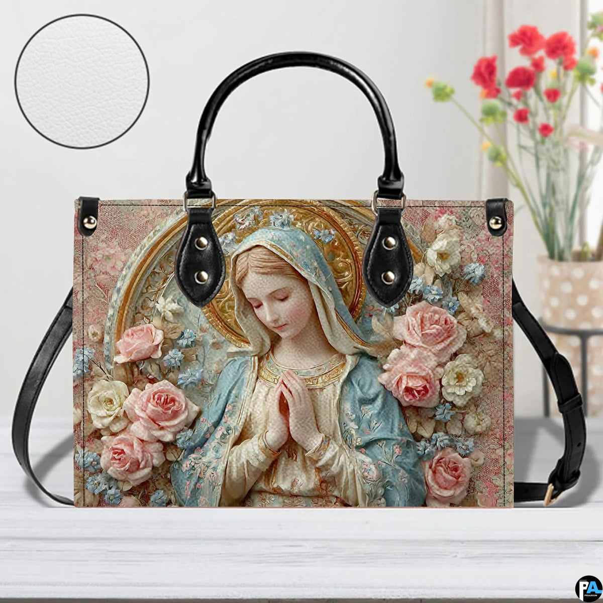 Tabletop display of porcelain Madonna handbag highlighting sculpted roses and golden halo