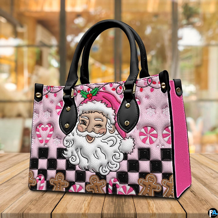 Perspective view of pink Santa handbag resting on a wooden tabletop.