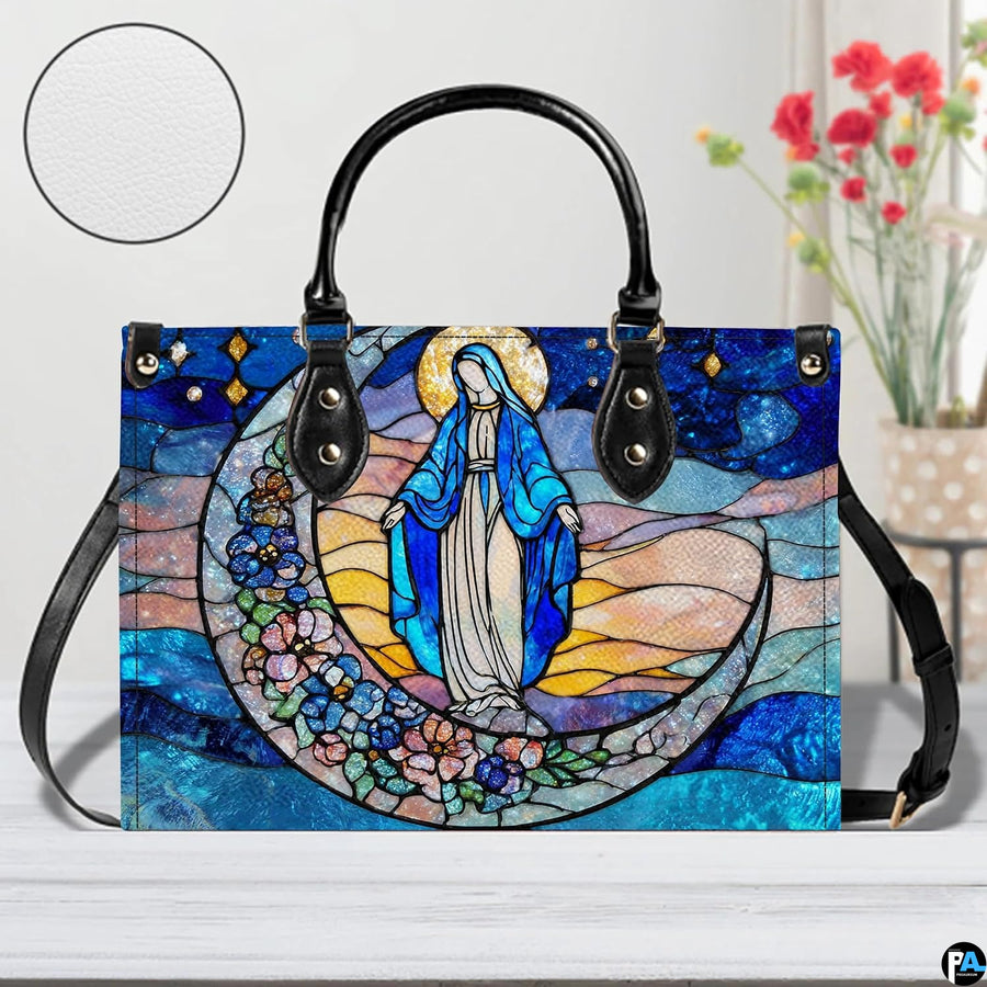 Stained glass Marian handbag shown on white wooden surface with texture swatch and background floral vase.