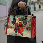 Lifestyle display of the vintage patriotic Santa handbag carried over the shoulder.