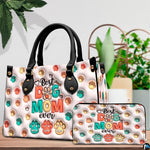 Close-up front view of colorful embossed paw prints on structured tote handbag