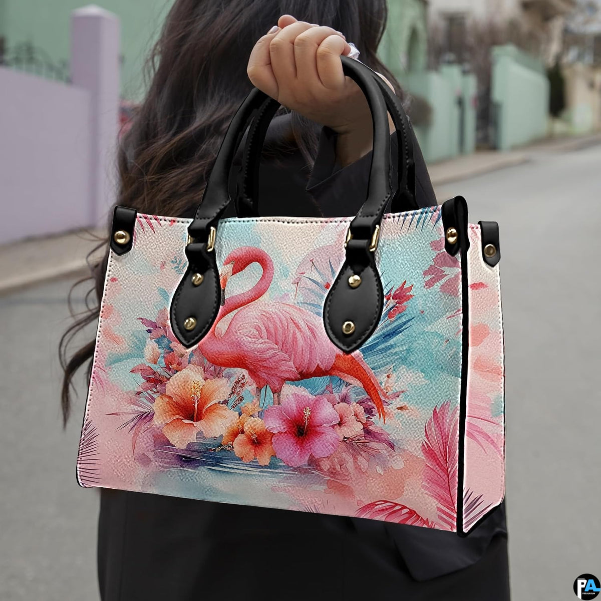 Outdoor lifestyle view of model carrying the tropical floral flamingo handbag.