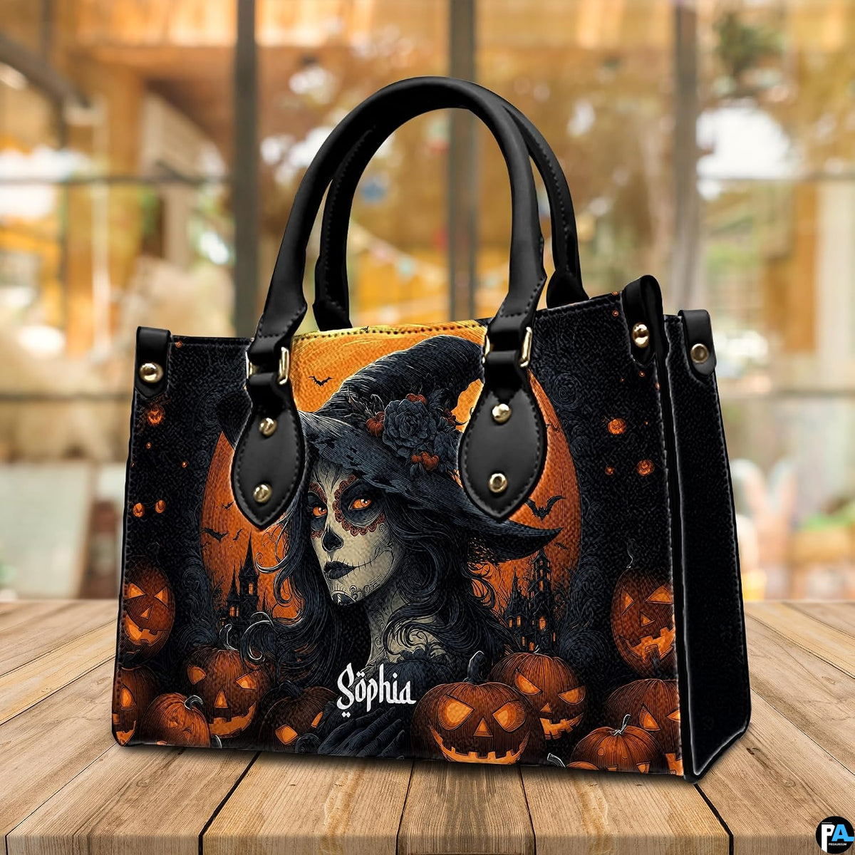 Halloween witch handbag displayed on wooden tabletop in front of sunlit window.