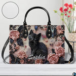 Close-up front view of matching zippered wallet showing black kitten portrait