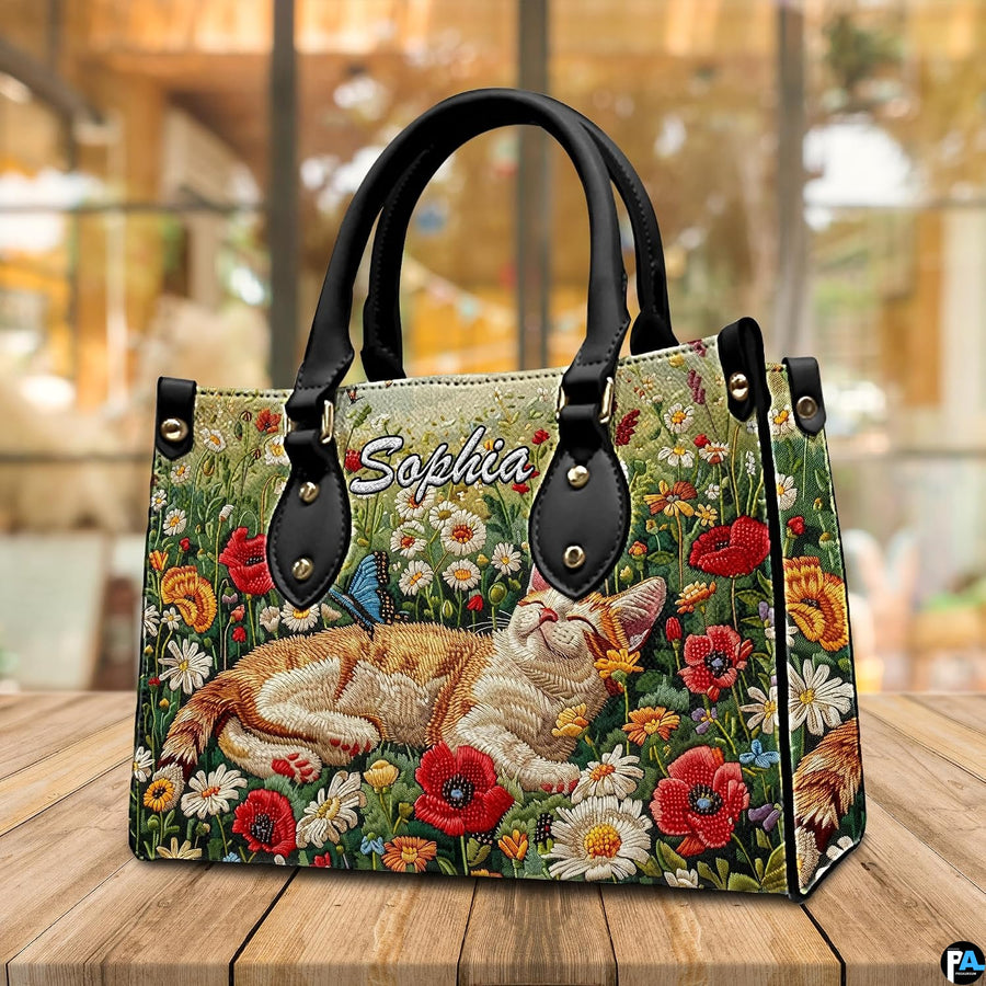 Angled tabletop perspective highlighting sleeping tabby cat graphic and colorful floral side profile.