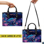 Matching wallet displaying the radiant celestial sea turtle amidst floral ocean foliage.
